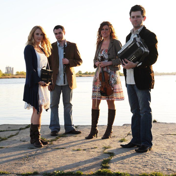 Nik Gaviskey band standing by pier with their instruments